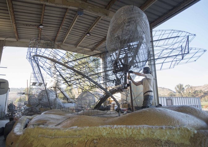 18Rose Float Koerner9-Elijah Koerner, a mechanical engineering major, grinds away on the  Cal Poly Universities Rose Float, Dreams Take Flight, December 14, 2017.