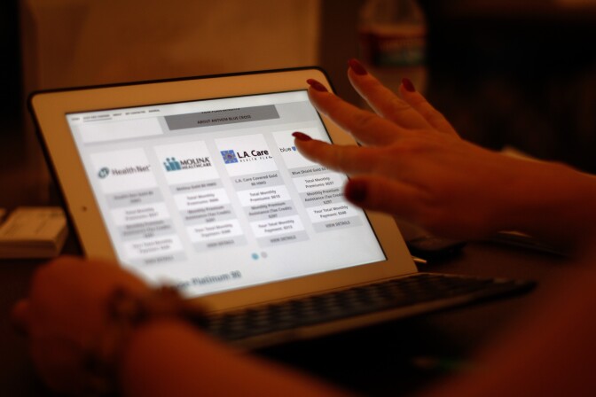 PASADENA, CA - NOVEMBER 19:  A healthcare reform specialist helps people select insurance plans at the free Affordable Care Act (ACA) Enrollment Fair at Pasadena City College on November 19, 2013 in Pasadena, California. The event, sponsored by the Chamber of Commerce and the Los Angeles Association of Health Underwriters, offers one-on-one sessions with insurance experts certified by Covered California to help people enroll for healthcare coverage under the ACA.  (Photo by David McNew/Getty Images)