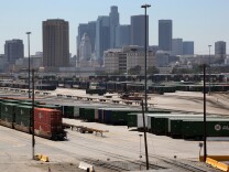 The Union Pacific Intermodal rail yard is viewed with the Los Angeles skyline on Friday, Aug. 28, 2015. The vast extension of land could be repurposed as the centerpiece of the proposed $1 billion residential village for the 2024 Olympic Games bid. But with a deadline to submit a U.S. candidate for the 2024 Games just 18 days away, the plan remains a mystery in many ways. The sprawling Olympic Village, to be built with mostly private funds, is tethered to a series of financial assumptions and question marks. (AP Photo/Richard Vogel)