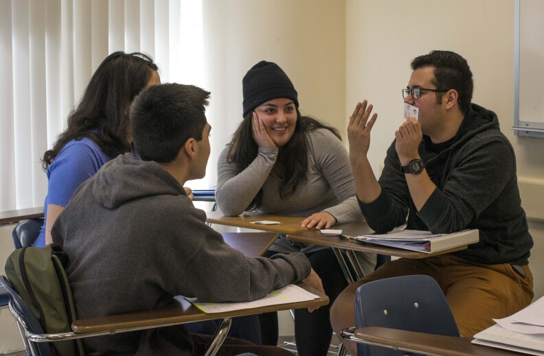 Left to right, students Pablo Andujo (back to camera), Mary Becerra (back to camera), Stephanie Lomeli, and Omar Guitiérrez practice speaking Serrano in a class at Cal State San Bernardino. None of the students in the class have Serrano heritage; most enrolled out of curiousity.