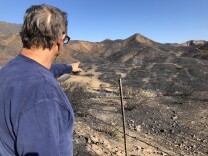 Retired Firefighter Rick Canter explains the path of the wildfire.