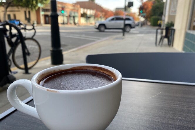 A dark hot chocolate sits on a table in Pasadena. 