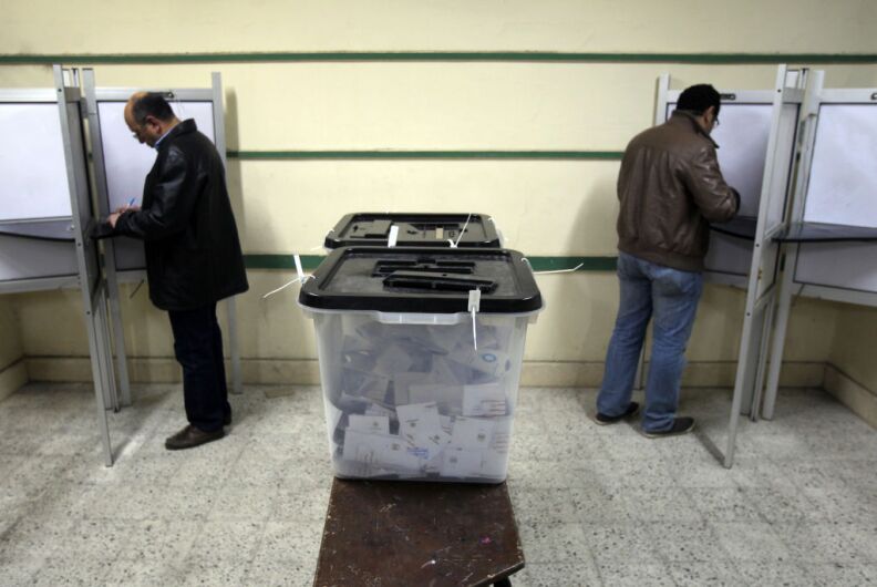 Egyptian men cast their ballots during the second round of a referendum on a new draft constitution in Giza, south of Cairo, on December 22, 2012. Egyptians are voting in the final round of a referendum on a new constitution championed by President Mohamed Morsi and his Islamist allies against fierce protests from the secular-leaning opposition.