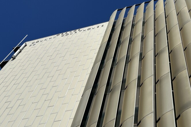 A view of a tall building from closeup and below.