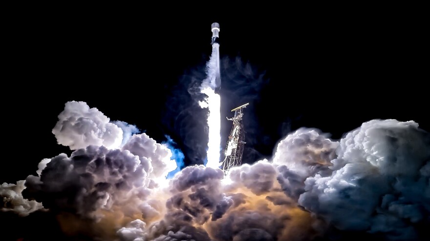 A rocket launches leaving smoke underneath it.