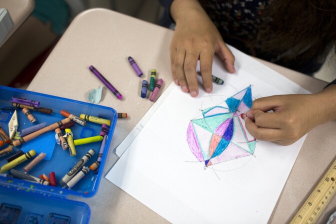 Geometry students at Hawthorne High School color in their artworks inspired by Wassily Kandinsky's "Circles in a Circle" painting. Teacher Ding-ay Tadena asks students to title their work when they're finished.