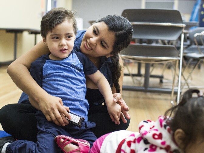 Francis Amaya and her 3-year-old son, Raul Cardosa, listen during reading time at a parent training put on by the Children's Bureau at the Pico Union Branch Library on Friday morning, May 20, 2016. A recent study found that of the 260,000 three and four year-olds in the County,  there are only enough licensed preschool seats for 160 thousand.