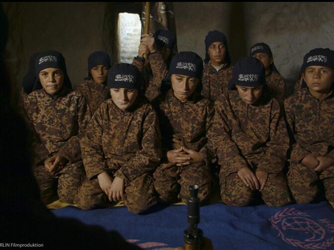 In "Of Fathers and Sons", filmmaker Talal Derki observes the radicalization of children in an Islamist community in Syria.