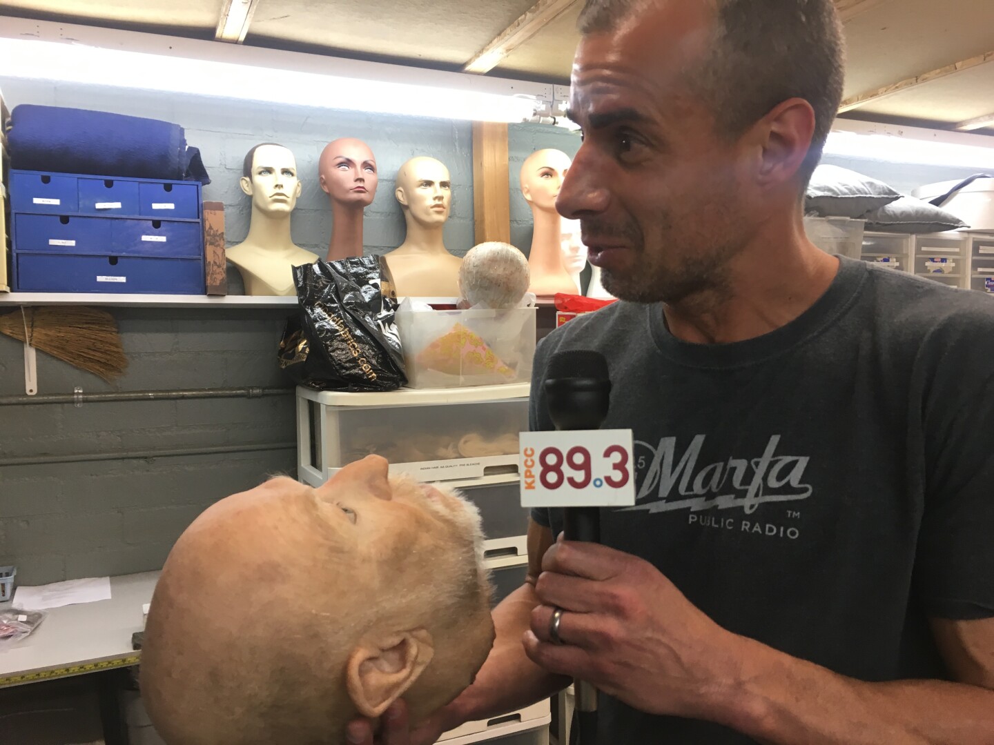 A Martinez holds a decapitated prosthetic head 
