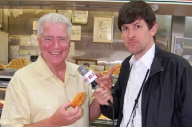 Huell Howser (with donut) and KPCC's John Rabe.