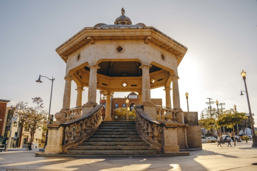 A large gazebo has peach-tones and a sweeping staircase