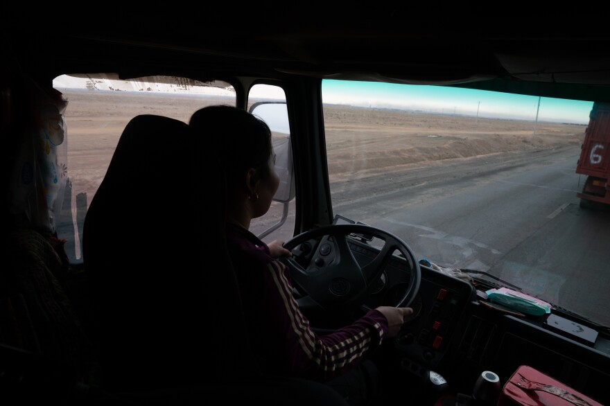 Gulnara Dariiga, 38, drives a truck piled high with coal as she waits to cross the border. A mining boom in the Gobi Desert is fueling cross-border trade between Mongolia and China, with millions of tons of coal, copper and precious minerals moving by the truckload every year.