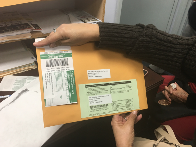 Dilcia Inestroza, an immigrant from Honduras, holds her renewal package for Temporary Protected Status. She's had the protected status, which lets her live and work legally in the United States, for nearly 20 years. It was granted to Honduran immigrants in the U.S. after Hurricane Mitch devastated that country in 1998. She fears this could be the last time she's allowed to renew her protection.