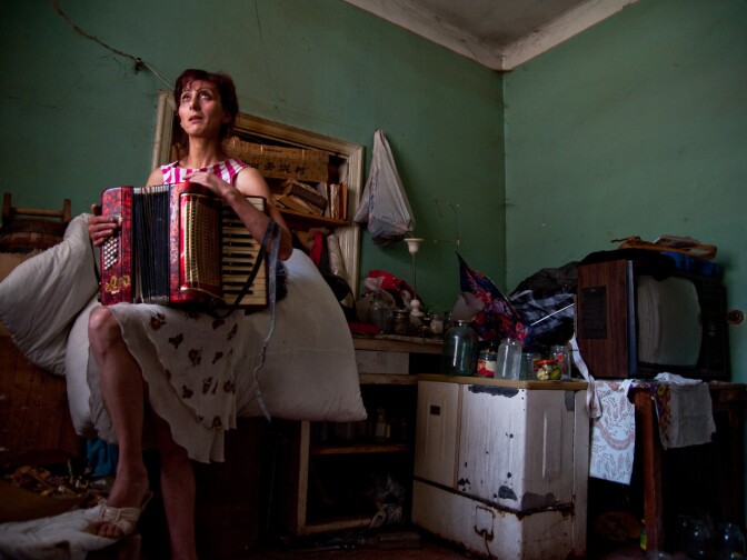 Narine Simonian, 40, with the accordion she once played as a young girl. Narine lives with her four children in Arinch, a town located just outside of Armenia’s capital city Yerevan.  
