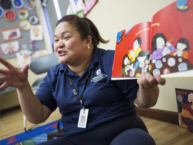 Teacher Rochelle Cabreros Flores reads a book about dim sum for Asian American Pacific Islander month during a parent training put on by the Children's Bureau at the Pico Union Branch Library on Friday morning, May 20, 2016.