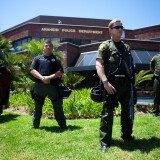 ANAHEIM, CA - JULY 29:  A line of police officers guard the Anaheim Police Department before a protest to show outrage for the several recent officer-involved shootings on July 29, 2012 in Anaheim, California. For the past week, protesters have clashed with police resulting in both property damage and many arrests.  (Photo by Jonathan Gibby/Getty Images)