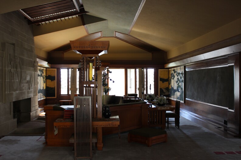 The living room contains a grand fireplace with a concrete bas-relief sculpture, which is one of the most important works of Wright's entire career according to Hollyhock House curator Jeffrey Herr. 