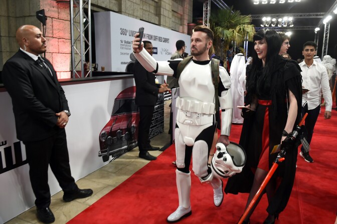 Guests, dressed in cosplay, arrive for the screening of "Star Wars: The Last Jedi" after the closing ceremony of the Dubai International Film Festival, in Dubai on December 13, 2017.