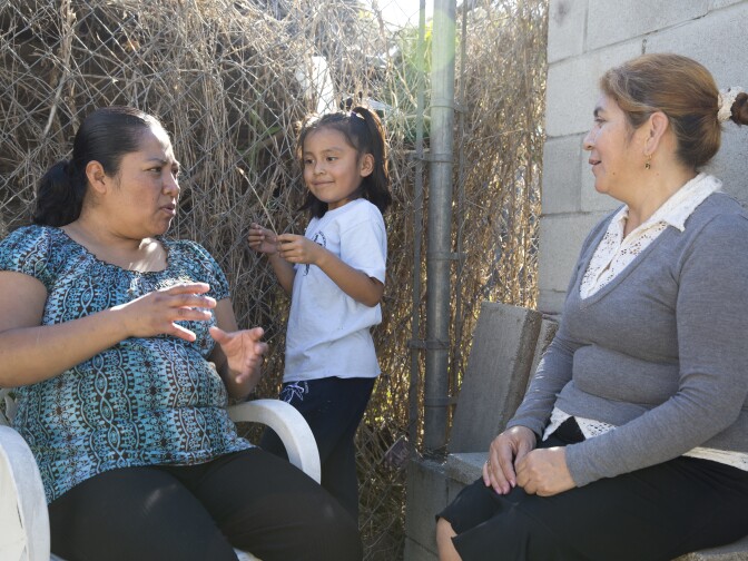Rocio Alfaro (left), Wendy Mendez (middle) and Mery Alvarez (right) attend a lunch on Feb. 10, 2016 in Watts where the topic of conversation was the upcoming 2016 elections.