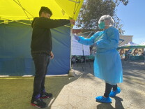  A student places a nasal swab from a COVID-19 test into a tube at an L.A. Unified School District screening site at San Fernando Middle School in March 2021.