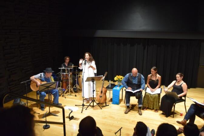 Guitarist and composer David Batteau (left) accompanies singer Perla Batalla (center) during a stage reading of "The Blue House."