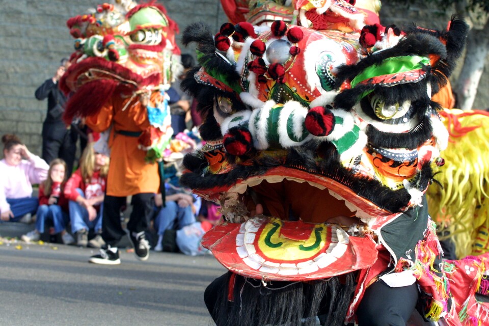 People participate in the Golden Dragon Parade in Chinatown in Los Angeles during the annual celebration of the Lunar New Year.
