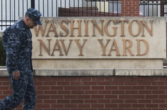 A US Navy sailor arrives at the front gate of the Washington Naval Yard September 17, 2013 in Washington, DC. Thirteen people were shot and killed by a lone gunman during a shooting rampage at the Navy Yard before police killed the gunman on September 16, 2013.