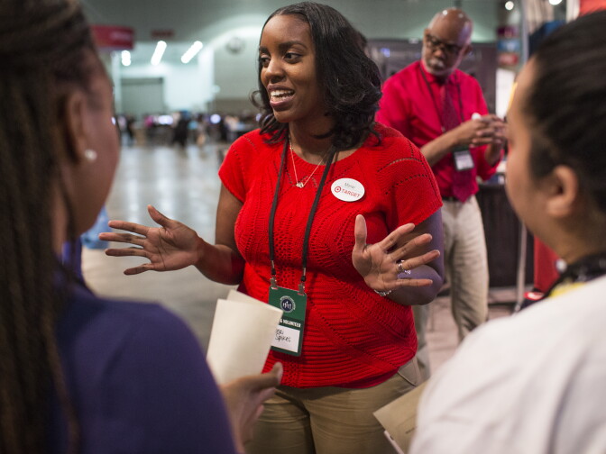 Mona Spikes is an executive team leader for human resources at Target. Spikes speaks with job candidates about their resumes at the Los Angeles Convention Center on Thursday morning, Feb. 11, 2016 during the Los Angeles Opportunity Hiring Fair.
