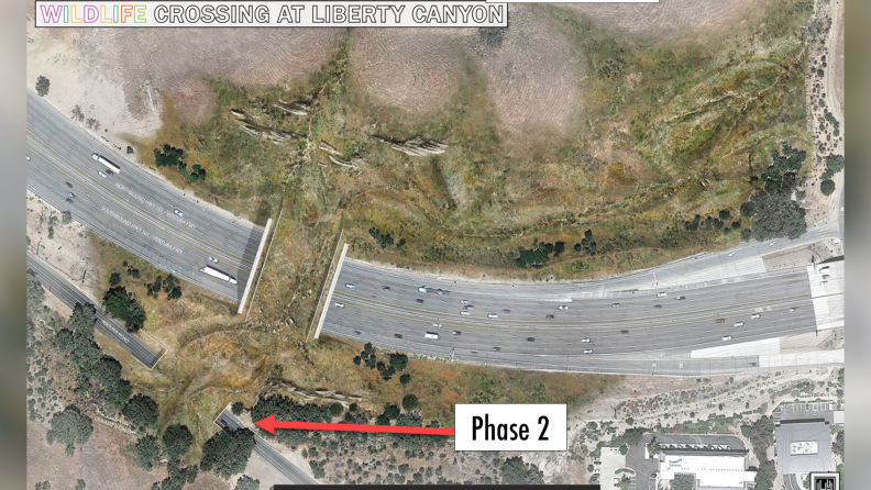 An overhead view of the 101 freeway with a land bridge covered in grass spanning it.