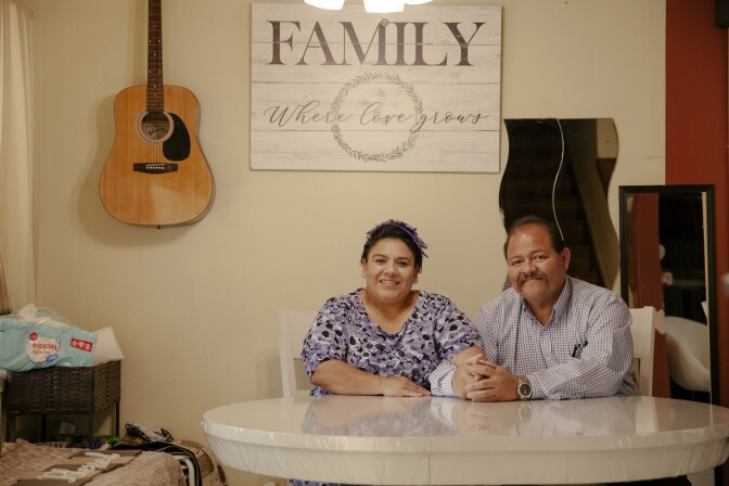 Rafael Aguilar and his wife sit at a table in their Boyle Heights home.