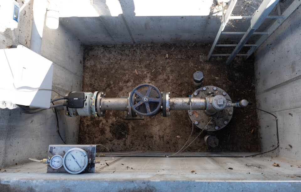 Pipes in a box going into the ground.
