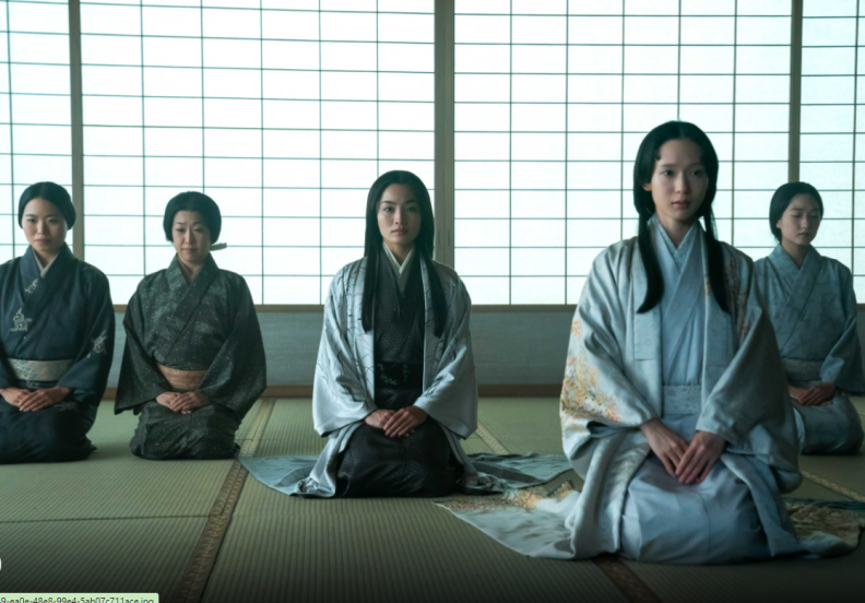 5 women sit on their knees with their hands folded in their laps