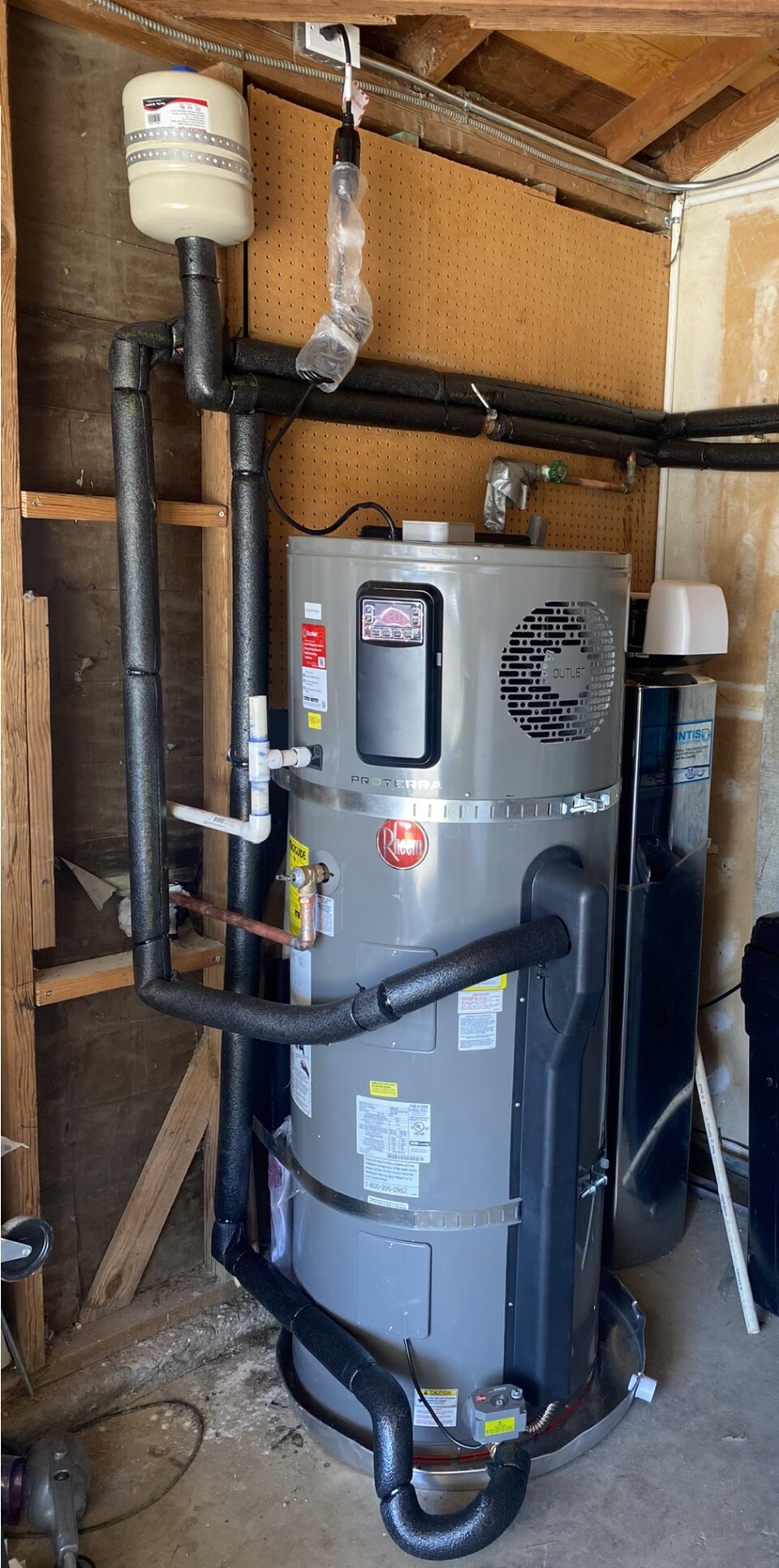 An image of a heat pump water heater in a basement. 