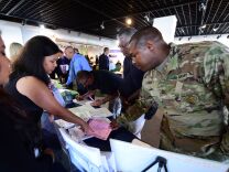 US Army Sergeant Kierre Tate (R) inquires about employment prospects at the first Los Angeles International Airport (LAX) Job Fair for Veterans in Los Angeles, California on September 14, 2016, where more than 20 airport employers were on hand with airport officials to support local veterans in seeking employment.  / AFP / Frederic J. BROWN        (Photo credit should read FREDERIC J. BROWN/AFP/Getty Images)