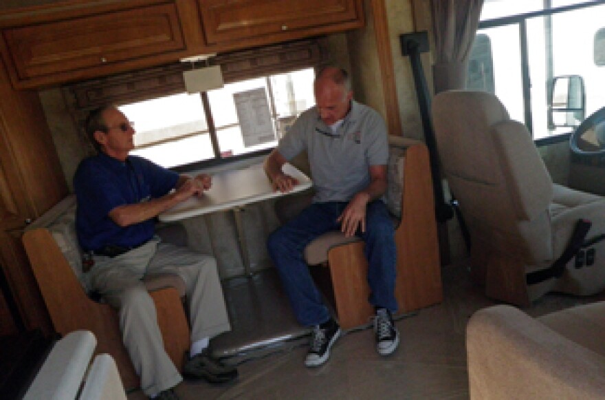 RV salesman Bob Lacey, left, and Altmans Winnebago president Joe Altman, right, talk inside an RV at Altmans Winnebago. Altmans Winnebago is closing after 40 years.