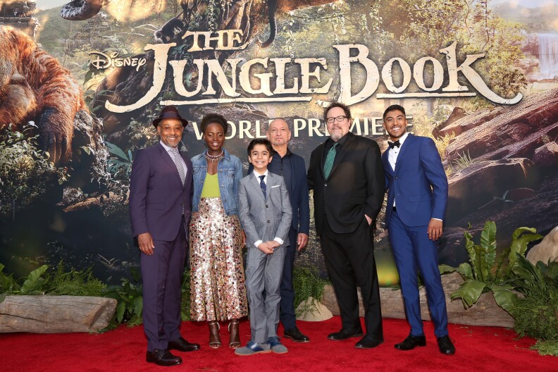 HOLLYWOOD, CALIFORNIA - APRIL 04:  (L-R) Actors Giancarlo Esposito, Lupita Nyong'o, Neel Sethi, Ben Kingsley, director/producer Jon Favreau and actor Ritesh Rajan attend The World Premiere of Disney's "THE JUNGLE BOOK" at the El Capitan Theatre on April 4, 2016 in Hollywood, California.  (Photo by Jesse Grant/Getty Images for Disney)
