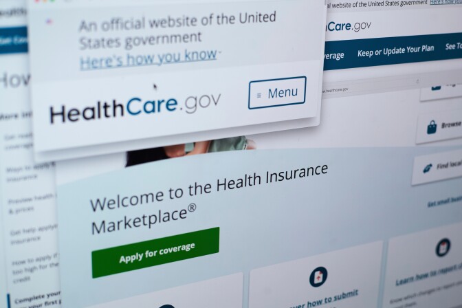 A screen displays the homepage of healthcare.gov.