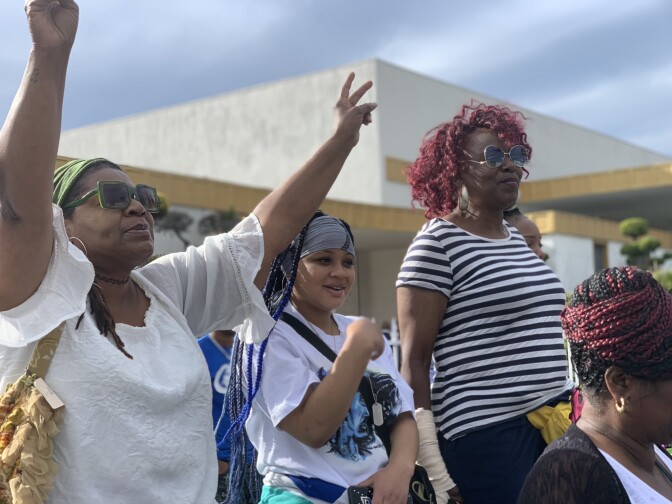 Fans chanting, “We Are Nipsey!” from the best seat in the house –– a green bus bench on an otherwise bare sidewalk outside the funeral home. 