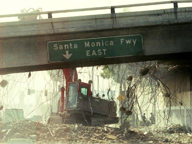 A bulldozer begins to tear down a section of the Santa Monica Freeway Jan. 19, 1994 that collapsed during the Northridge earthquake. Commuters were urged to leave for work two hours earlier due to the 300 foot section of the road that was closed.