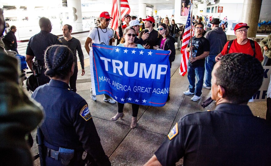 Trump supporters lead a counter-protest of the executive order by US President Donald Trump, banning immigrants from seven majority-Muslim countries at Los Angeles International Airport, California on February 4, 2017.   / AFP / Kyle Grillot        (Photo credit should read KYLE GRILLOT/AFP/Getty Images)