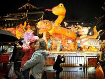 Visitors look at a display celebrating Chinese lunar new year in Shanghai on February 8, 2013. Preparations continue in China for the Lunar New Year which will celebrate the Year of the Snake on February 10.