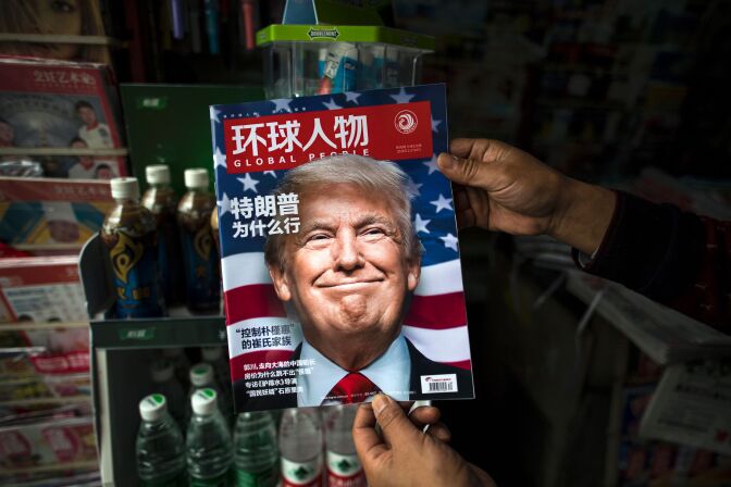 TOPSHOT - A copy of the local Chinese magazine Global People with a cover story that translates to "Why did Trump win" is seen with a front cover portrait of US president-elect Donald Trump at a news stand in Shanghai on November 14, 2016.  
Chinese President Xi Jinping and US president-elect Donald Trump agreed November 14 to meet "at an early date" to discuss the relationship between their two powers, Chinese state broadcaster CCTV said.  / AFP / JOHANNES EISELE        (Photo credit should read JOHANNES EISELE/AFP/Getty Images)