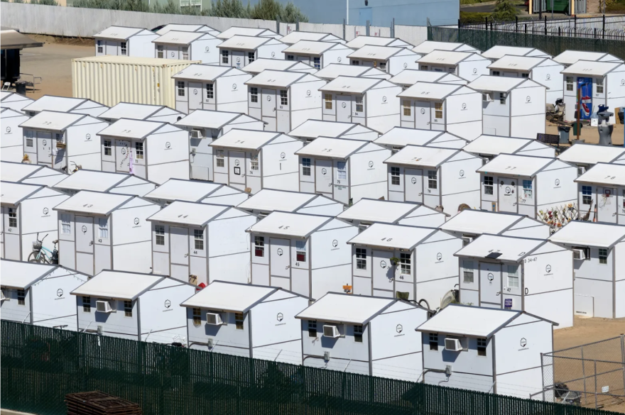 Rows upon rows of small white houses that look nearly identical to each other.
