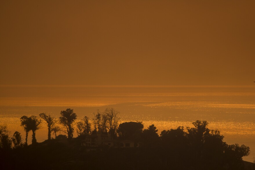 MONTECITO, CA - DECEMBER 16: Smoke fills the sky over the ocean beyond homes threatened by the Thomas Fire on December 16, 2017 in Montecito, California. The National Weather Service has issued red flag warnings of dangerous fire weather in Southern California for the duration of the weekend. Prior to the weekend, Los Angeles and Ventura counties had 12 consecutive days of red flag fire warnings, the longest sustained period of fire weather warnings on record. The Thomas Fire is currently the fourth largest California fire since records began in 1932, growing to 400 square miles and destroying more than 1,000 structures since it began on December 4. (Photo by David McNew/Getty Images)