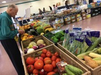 A volunteer with the Saddleback Church prepares produce as part of the group's food pantry on the Camp Pendleton Marine Base near San Diego, April 5, 2017. The church typically serves about 100 active duty military families as part of its monthly food pantry.