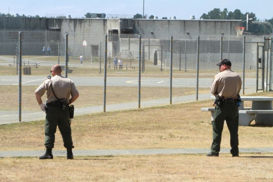 In this Aug. 17, 2011 file photo,  correctional officers keep watch on inmates on the recreation yard at Pelican Bay State Prison near Crescent City, Calif. Authorities say that Mexican Mafia member Danny Roman, serving a life sentence at Pelican Bay, gave orders to over two dozen gang members to commit crimes.