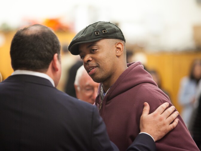 Al Gordon interacts with city council candidate Steve Veres before the beginning of the candidate forum.  Al Gordon, who works as a chef at the Los Feliz restaurant Community, was attending a council district 4 candidate forum for the first time at Ivanhoe Elementary School in Los Angeles, Calif.  