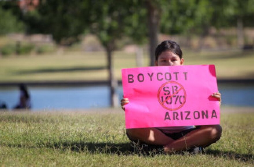 Litzy Medina waits waits to join a march through downtown to protest Arizona's controversial immigration law SB1070