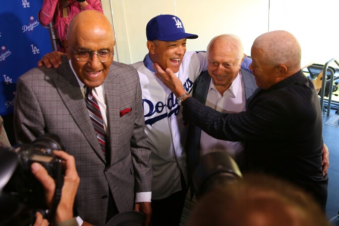 LOS ANGELES, CA - DECEMBER 01:  Former Dodgers player Maury Wills, right, congratulates Dave Roberts on his position as the new Los Angeles Dodgers manager as former Dodgers player Don Newcombe, left, and former Dodgers manager Tommy Lasorda, second from right, look on at Dodger Stadium on December 1, 2015 in Los Angeles, California.  (Photo by Victor Decolongon/Getty Images)