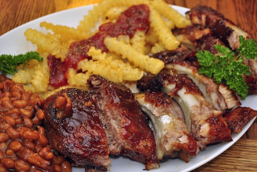 barbecued ribs with a side of baked beans and fries